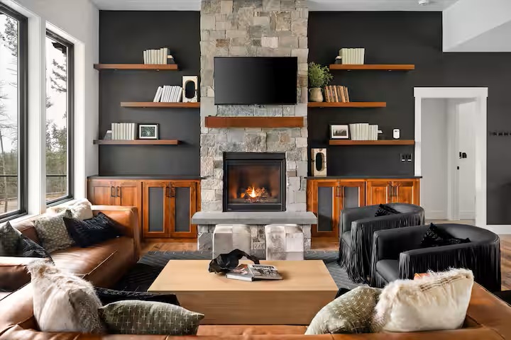 Great room with stone fireplace, leather sofas and built-in shelving
