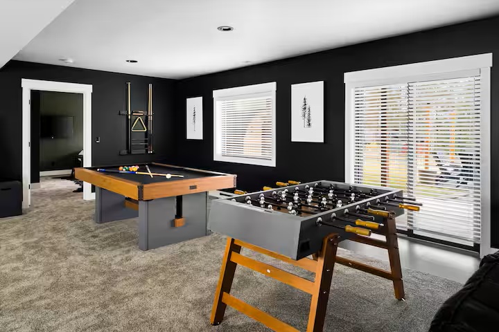 Game room with pool table and foosball table